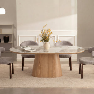 Round ceramic dining table featuring a marble-look top and tapered wood pedestal