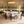 Oval white micro cement dining table with four black bouclé chairs