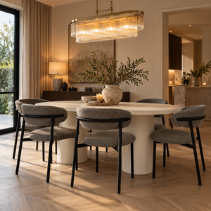 Oval micro cement dining table with six gray upholstered black chairs