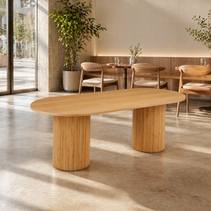 Wooden dining table in a modern interior setting with chairs and plants.