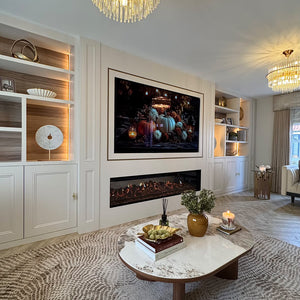 Round ceramic coffee table with white stone-look surface and walnut legs in front of fireplace