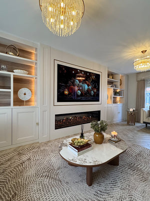 Round ceramic coffee table with white stone-look surface and walnut legs in front of fireplace