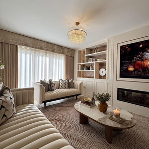 Round ceramic coffee table with white stone-look top and walnut legs in living room