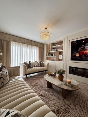 Round ceramic coffee table with white stone-look top and walnut legs in living room