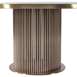 A modern round table featuring a fluted metallic pedestal base in a brushed gold finish, with a light-colored stone top partially visible at the top edge, set against a plain white background.