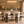 Oval micro cement dining table with six black bouclé dining chairs
