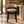 Upholstered barstool with light gray fabric seat and back, black legs.