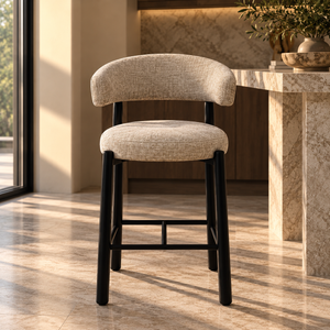 Upholstered barstool with light gray fabric seat and back, black legs.