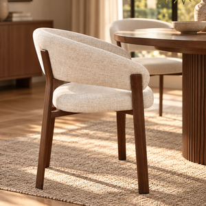Upholstered dining chair with curved beige back and seat, walnut finish wooden legs