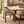 Walnut dining table with light marble-look top and four beige upholstered armchairs