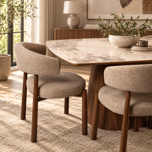 Walnut dining table with light marble-look top and four beige upholstered armchairs
