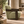 Henry Sage Armchair side view with rounded green seat and dark wood frame