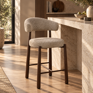 Beige upholstered barstool with curved backrest, dark wood legs and X-style footrest.