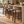 Set of upholstered barstools with beige fabric seats, rounded backs, dark wood frames.