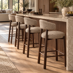 Set of upholstered barstools with beige fabric seats, rounded backs, dark wood frames.
