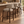 Upholstered barstool with beige fabric seat and rounded back, dark wood legs, footrest.
