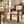 Cream fabric dining chair with wide arms and walnut wood frame, front view.