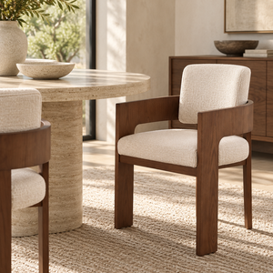 Cream fabric dining chair with wide arms and walnut wood frame, front view.