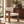 Cream upholstered dining chair with walnut wood arms and straight legs.