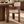 Walnut wood dining chair with cream upholstered seat and curved backrest edge.