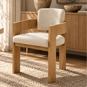 Cream upholstered dining chair with oak armrests and curved back, front view