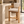 Light oak barstool with cream upholstered seat, wide arms, open bottom footrest