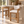 Set of two light oak barstools with cream upholstered seats and backs, open footrests