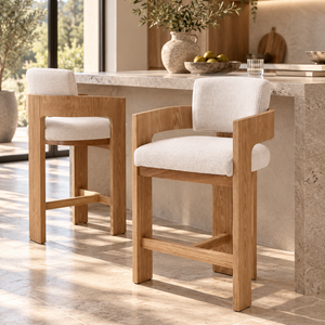 Set of two light oak barstools with cream upholstered seats and backs, open footrests