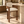Walnut wood barstool with cream upholstered back and seat, front view with footrest
