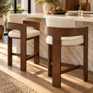 Walnut barstool with cream fabric seat and back, showing square apron and footrest
