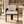 Cream upholstered dining chair with dark wood arms and legs