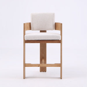 A modern wooden bar stool with a light beige upholstered seat and backrest, shown against a plain white background.