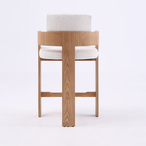 A modern wooden dining chair with a curved backrest, light oak wood frame, and off-white textured fabric seat and back cushions, shown against a plain white studio background.