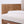Close-up detail of a modern wooden chair with a light beige textured fabric seat cushion and a natural wood frame against a white background.