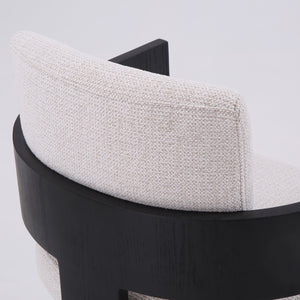 Close-up of a modern chair back with a textured off-white fabric cushion and a curved black wooden frame, shown against a plain white background.