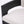 Close-up of a modern chair showing a curved black wooden frame and a light beige textured fabric seat cushion against a plain white background.