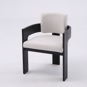 A modern accent chair featuring a black wooden frame and light beige textured fabric upholstery on the seat and backrest, photographed against a seamless white studio background.