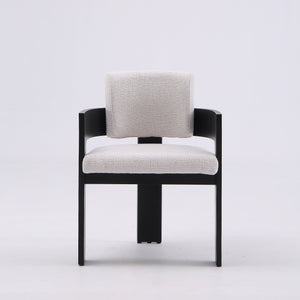 A modern accent chair with a black wooden frame and light beige textured fabric upholstery on the seat and backrest, shown against a plain light gray studio background.