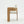 A modern wooden dining chair with a light oak frame and textured off-white fabric upholstery, shown from a side profile against a clean white background.