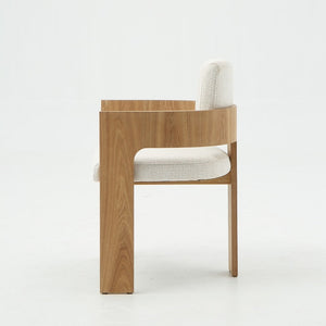 A modern wooden dining chair with a light oak frame and textured off-white fabric upholstery, shown from a side profile against a clean white background.