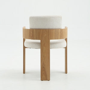 A modern wooden dining chair with a curved light oak frame and light beige textured bouclé upholstery on the seat and back cushion, shown against a plain white studio background.