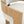 Close-up of a modern upholstered chair showing a light oak wood frame and textured off-white fabric seat and back cushion on a white background.