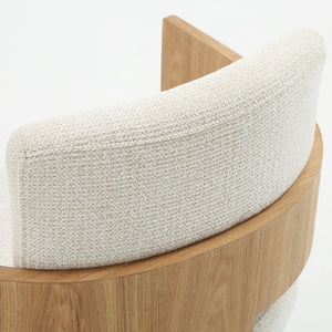 Close-up of a curved wooden chair with a thick, textured cream fabric backrest and seat cushion on a white background.