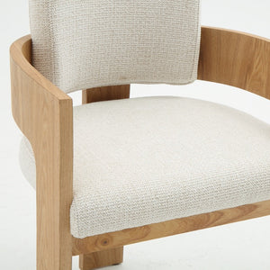 A modern wooden armchair with a curved natural oak frame and textured off-white woven upholstery on the seat and backrest, shown against a plain white background.