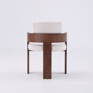 A modern wooden armchair with a curved dark brown frame and light beige textured fabric upholstery on the seat and backrest, shown against a plain white studio background.
