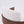 Close-up of a curved wooden chair with a textured off-white fabric seat and back cushion, shown against a plain white background.