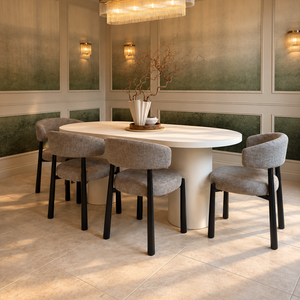 Oval white dining table with four gray upholstered chairs and black legs