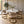Round white marble dining table with gold base and veined stone tabletop