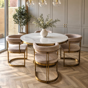 Round white marble dining table with gold base and veined stone tabletop