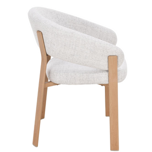 Side view of light gray upholstered dining chair with rounded arms and oak frame